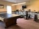 Exercise area features a ping pong table, a fan, and a variety of exercise equipment at 1353 Mission Cir, Clearwater, FL 33759