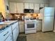 Efficient kitchen featuring white appliances, ample counter space and lots of cabinets at 1353 Mission Cir, Clearwater, FL 33759