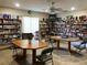 Inviting recreation room with floor to ceiling bookshelves and tables for puzzles and games at 1353 Mission Cir, Clearwater, FL 33759