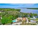 Aerial view of the community pool, lake, and surrounding landscape at 1487 Dundee Dr, Palm Harbor, FL 34684