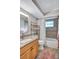 Neutral bathroom featuring granite vanity top, tile floors, and a shower-tub combo at 1487 Dundee Dr, Palm Harbor, FL 34684