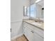 Bathroom featuring granite vanity top, tile floors, and white cabinets at 1487 Dundee Dr, Palm Harbor, FL 34684