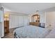 Neutral bedroom features wood-look floors, closet, and light colored walls at 1487 Dundee Dr, Palm Harbor, FL 34684