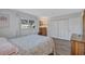 Bright bedroom featuring wood-look floors, one window with blinds, and light colored walls at 1487 Dundee Dr, Palm Harbor, FL 34684