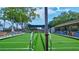 View of bocce ball courts, surrounded by seating and greenery, offering a recreational outdoor space at 1487 Dundee Dr, Palm Harbor, FL 34684