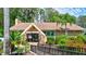 Exterior shot of the Lake Tarpon Lodge with manicured landscaping and a welcoming entrance at 1487 Dundee Dr, Palm Harbor, FL 34684