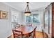 Inviting dining area with wood floors, table, and decorative chandelier, near the kitchen and with exterior views at 1487 Dundee Dr, Palm Harbor, FL 34684