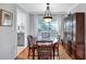 Dining room with hardwood floors and a view into the renovated kitchen at 1487 Dundee Dr, Palm Harbor, FL 34684