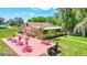 Exterior aerial view of building with picnic tables, grills, landscaping, and lake access at 1487 Dundee Dr, Palm Harbor, FL 34684