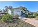 Cozy single Gathering home with an attached single garage, green grass, and driveway at 1487 Dundee Dr, Palm Harbor, FL 34684