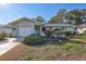 Charming single-story home featuring a well-manicured front yard with lush landscaping and inviting curb appeal at 1487 Dundee Dr, Palm Harbor, FL 34684