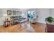 Bright living room with hardwood floors, large windows, and neutral decor creating a comfortable living space at 1487 Dundee Dr, Palm Harbor, FL 34684