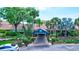 The main entrance to the facility is landscaped with palm trees and greenery at 1487 Dundee Dr, Palm Harbor, FL 34684