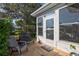 Enclosed sunroom with seating and ample natural light, perfect for relaxation at 1487 Dundee Dr, Palm Harbor, FL 34684