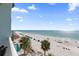 Balcony view of the gulf with palm trees and beachside lounging at 17200 Gulf Blvd # 302, North Redington Beach, FL 33708