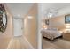 Hallway leading into a bedroom, featuring wood floors at 17200 Gulf Blvd # 302, North Redington Beach, FL 33708