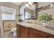 Bathroom with granite vanity, decorative mirror, tile backsplash, and tile flooring at 1721 S Jefferson Ave, Clearwater, FL 33756