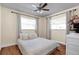 Bright bedroom with hardwood floors, neutral walls, white trim and a double set of windows at 1721 S Jefferson Ave, Clearwater, FL 33756