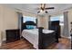 Comfortable bedroom featuring dark wood furnishings, ceiling fan, and bright windows at 1721 S Jefferson Ave, Clearwater, FL 33756