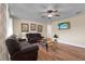 Cozy living room featuring ceiling fan, wood flooring, and large comfortable leather sofas at 1721 S Jefferson Ave, Clearwater, FL 33756