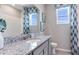 Contemporary bathroom featuring granite countertop, modern fixtures, stylish mirror and an abundance of natural light at 18126 Cropside Trl, Lakewood Ranch, FL 34211