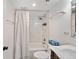 Bathroom featuring a shower-tub combo, marble vanity with sink and a decorative mirror at 201 W Laurel St # 909, Tampa, FL 33602