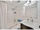 Bathroom featuring a shower-tub combo, marble vanity with sink and a decorative mirror at 201 W Laurel St # 909, Tampa, FL 33602