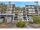 Condominium complex entrance with landscaped roundabout and building number at 201 W Laurel St # 909, Tampa, FL 33602