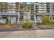 Condominium complex entrance with landscaped roundabout and building number at 201 W Laurel St # 909, Tampa, FL 33602