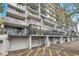 Low-angle view of condominium balconies and garage doors, offering secure parking at 201 W Laurel St # 909, Tampa, FL 33602