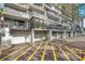 Low-angle view of condominium balconies and garage doors, offering secure parking at 201 W Laurel St # 909, Tampa, FL 33602