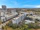 Aerial view of the condominium near the river with an outdoor pool and an adjacent city skyline at 201 W Laurel St # 909, Tampa, FL 33602