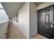 Hallway view to the apartment entrance, featuring a black door with a smart lock system and unit number at 201 W Laurel St # 909, Tampa, FL 33602