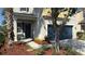 Inviting front porch with bench seating, colorful mulch, and a dark blue entry door at 21211 Southern Charm Dr, Land O Lakes, FL 34637