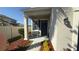 Inviting front porch with bench seating, colorful mulch, and a dark blue entry door at 21211 Southern Charm Dr, Land O Lakes, FL 34637