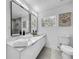 Modern bathroom with dual sinks, marble shower, and picture window at 2522 W North St, Tampa, FL 33614