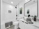 Modern bathroom featuring subway tile, white vanity, and updated fixtures at 2522 W North St, Tampa, FL 33614