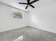 This bedroom features stylish gray tile flooring and a ceiling fan at 2522 W North St, Tampa, FL 33614