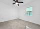 Bedroom showcasing a modern ceiling fan, window, and neutral decor at 2522 W North St, Tampa, FL 33614