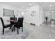 Dining area featuring a round wood table and elegant chairs, flowing into the hallway at 2522 W North St, Tampa, FL 33614