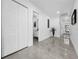 Hallway featuring light-grey tile flooring and access to a bathroom at 2522 W North St, Tampa, FL 33614