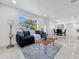 Bright living room featuring tile flooring, and seamlessly connecting to the dining area at 2522 W North St, Tampa, FL 33614