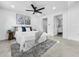 Bright main bedroom featuring a ceiling fan, neutral decor, and an en-suite bathroom at 2522 W North St, Tampa, FL 33614