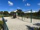 Community playground featuring slides, swings, and climbing structure near a lake at 3600 105Th N Ave, Clearwater, FL 33762