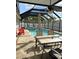 Sparkling pool with outdoor furniture and screened enclosure, providing a refreshing and relaxing outdoor space at 3600 105Th N Ave, Clearwater, FL 33762