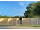 Racquetball courts with a tall fence, lighting and trees in the background at 3600 105Th N Ave, Clearwater, FL 33762