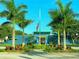 School building with an American flag, palm trees, and manicured landscaping at 3600 105Th N Ave, Clearwater, FL 33762