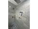 Modern shower with pebble flooring, tiled niche, rain shower head, and sleek fixtures at 3600 105Th N Ave, Clearwater, FL 33762