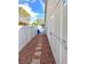 Side yard showing a pathway, fence, and exterior of the house that provides utility and access to outdoor amenities at 3600 105Th N Ave, Clearwater, FL 33762