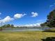 Community tennis court surrounded by green lawn and trees at 3600 105Th N Ave, Clearwater, FL 33762